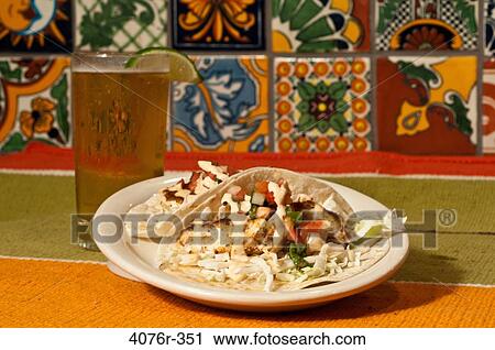 Close up of fish taco and glass of beer View Large Photo Image Stock Image - Close up of fish taco and glass of beer. Fotosearch