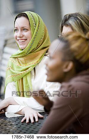 Close-up of girlfriends sitting together View Large Photo Image Stock Photo - Close-up of girlfriends sitting together. Fotosearch