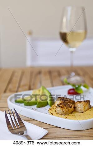 Close up of scallop appetizer with avocados and white wine View Large Photo Image Stock Photograph - Close up of scallop appetizer with avocados and white wine. Fotosearch