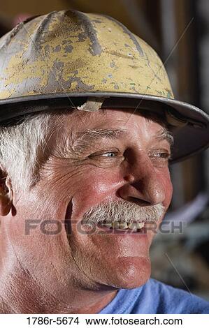 Close-up of senior man wearing hard hat View Large Photo Image Picture - Close-up of senior man wearing hard hat. Fotosearch