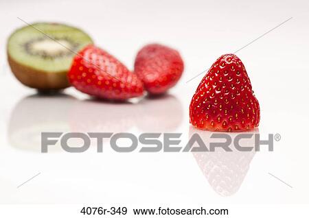 Close up of strawberries and kiwi on white background View Large Photo Image Stock Photo - Close up of strawberries and kiwi on white background. Fotosearch