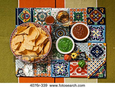 Close up of tortilla chips and salsa on colored tiles View Large Photo Image Stock Photo - Close up of tortilla chips and salsa on colored tiles. Fotosearch