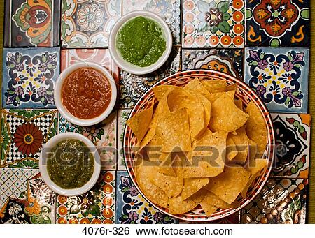 Close up of tortilla chips and salsa on colored tiles View Large Photo Image Stock Photograph - Close up of tortilla chips and salsa on colored tiles. Fotosearch