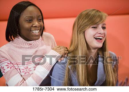 Picture - Close-up of two cheerful teenage girlfriends. Fotosearch
