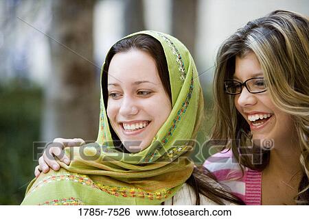 Close-up of two women friends smiling View Large Photo Image Stock Photograph - Close-up of two women friends smiling. Fotosearch