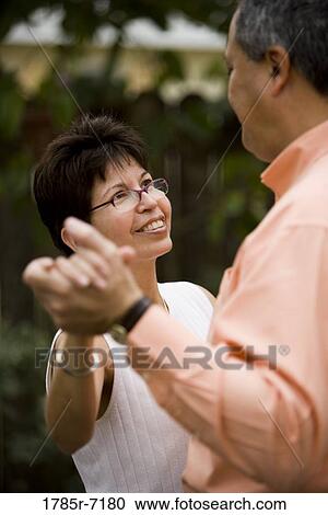 Stock Image - Close-up view of a mature couple dancing. Fotosearch