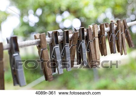 Clothespins hanging on clothesline View Large Photo Image Stock Image - Clothespins hanging on clothesline. Fotosearch