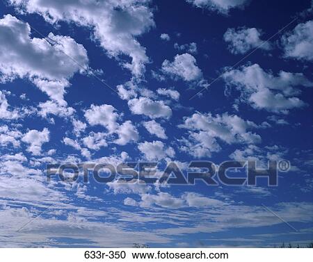 Clouds in a blue sky View Large Photo Image Stock Image - Clouds in a blue sky. Fotosearch