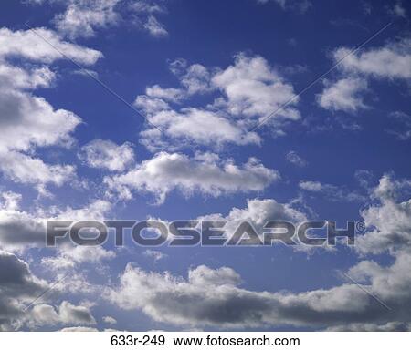 Clouds in a blue sky View Large Photo Image Stock Photo - Clouds in a blue sky. Fotosearch
