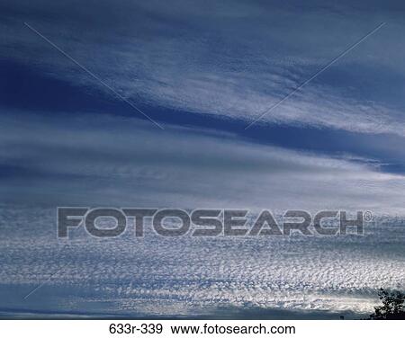 Clouds in a blue sky View Large Photo Image Stock Photo - Clouds in a blue sky. Fotosearch