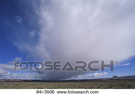Clouds over an arid landscape View Large Photo Image Stock Photograph - Clouds over an arid landscape. Fotosearch