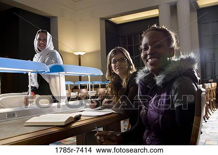 Picture - College students studying in library. Fotosearch