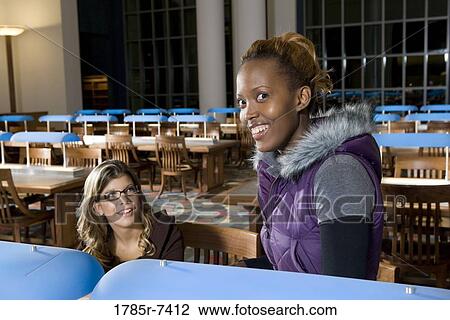 College students studying in library View Large Photo Image Stock Image - College students studying in library. Fotosearch