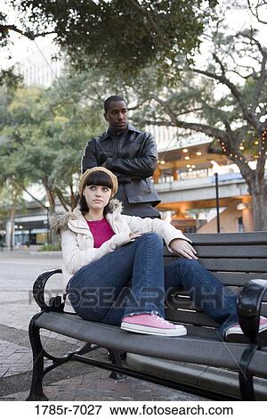 Contemplative young inter-racial couple at a city park View Large Photo Image Stock Photo - Contemplative young inter-racial couple at a city park. Fotosearch