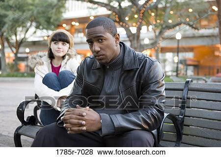 Contemplative young inter-racial couple at a city park View Large Photo Image Stock Photo - Contemplative young inter-racial couple at a city park. Fotosearch