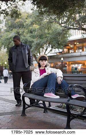 Contemplative young inter-racial couple at a city park View Large Photo Image Stock Photography - Contemplative young inter-racial couple at a city park. Fotosearch