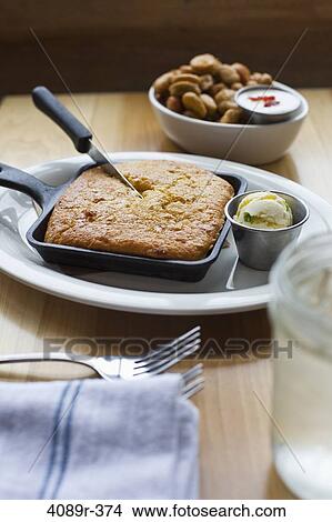 Corn bread in a skillet with water and fried jalapeno peppers View Large Photo Image Picture - Corn bread in a skillet with water and fried jalapeno peppers. Fotosearch