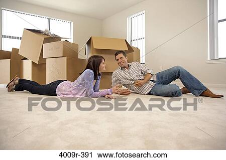 Couple drinking wine to celebrate moving into new home View Large Photo Image Stock Image - Couple drinking wine to celebrate moving into new home. Fotosearch