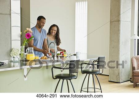 Couple making breakfast in loft apartment View Large Photo Image Stock Image - Couple making breakfast in loft apartment. Fotosearch