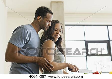 Couple making breakfast in loft apartment View Large Photo Image Stock Photo - Couple making breakfast in loft apartment. Fotosearch
