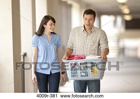 Couple on their way do to laundry View Large Photo Image Stock Image - Couple on their way do to laundry. Fotosearch