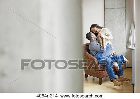 Picture - Couple relaxing in loft apartment. Fotosearch