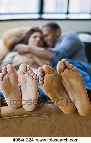 Couple relaxing in loft apartment View Large Photo Image Picture - Couple relaxing in loft apartment. Fotosearch