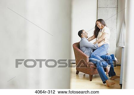 Couple relaxing in loft apartment View Large Photo Image Stock Image - Couple relaxing in loft apartment. Fotosearch