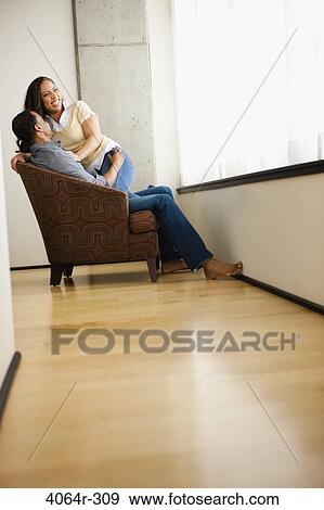 Couple relaxing in loft apartment View Large Photo Image Stock Photo - Couple relaxing in loft apartment. Fotosearch