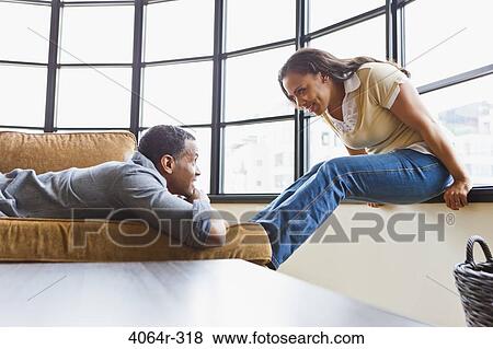 Stock Photo - Couple relaxing in loft apartment. Fotosearch