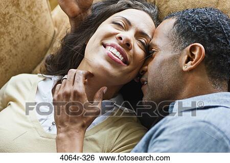 Couple relaxing in loft apartment View Large Photo Image Stock Photograph - Couple relaxing in loft apartment. Fotosearch