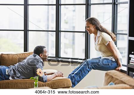 Couple relaxing in loft apartment View Large Photo Image Stock Photography - Couple relaxing in loft apartment. Fotosearch