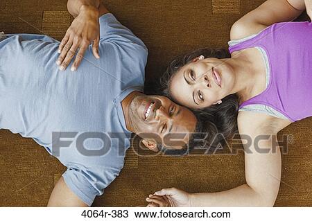 Couple relaxing on floor View Large Photo Image Stock Image - Couple relaxing on floor. Fotosearch