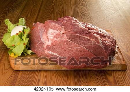 Cuadril de ternera with vegetables on a cutting board View Large Photo Image Stock Photography - Cuadril de ternera with vegetables on a cutting board. Fotosearch