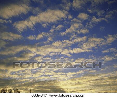 Stock Photo - Cumulus clouds in a blue sky. Fotosearch