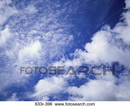 Stock Photograph - Cumulus clouds in a blue sky. Fotosearch