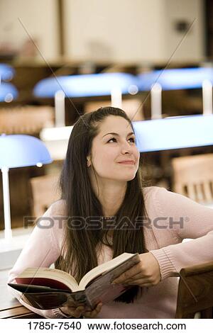 Elevated view of a young woman studying in the reading room of a library View Large Photo Image Stock Image - Elevated view of a young woman studying in the reading room of a library. Fotosearch