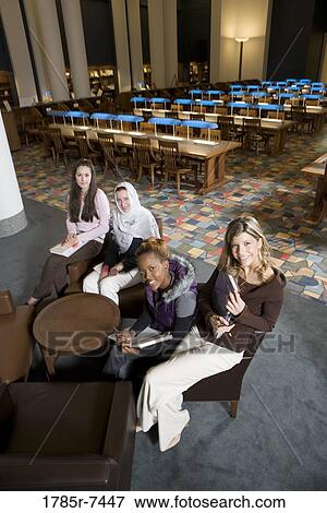 Elevated view of four women students in a sitting lounge in a library View Large Photo Image Stock Photo - Elevated view of four women students in a sitting lounge in a library. Fotosearch