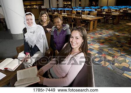Elevated view of four women students in a sitting lounge in a library View Large Photo Image Stock Photo - Elevated view of four women students in a sitting lounge in a library. Fotosearch
