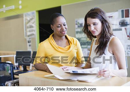 Employees collaborating at office View Large Photo Image Stock Image - Employees collaborating at office. Fotosearch