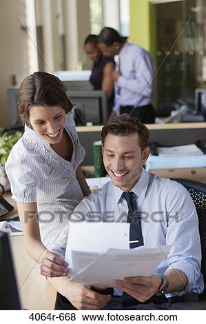 Stock Photo - Employees collaborating in office. Fotosearch