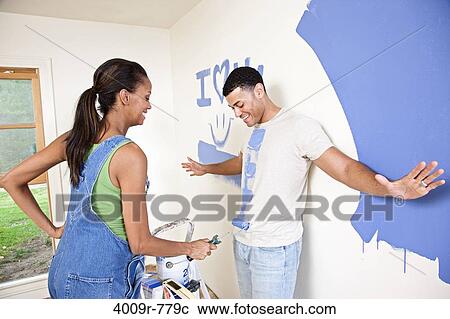 Expectant couple goofing off while painting nursery View Large Photo Image Stock Image - Expectant couple goofing off while painting nursery. Fotosearch