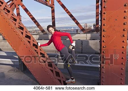 Female jogger, stretching on bridge View Large Photo Image Stock Image - Female jogger, stretching on bridge. Fotosearch