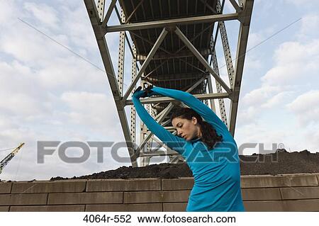 Female urban athlete stretching View Large Photo Image Stock Image - Female urban athlete stretching. Fotosearch