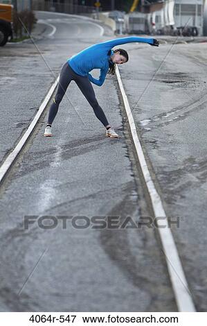 Stock Photo - Female urban athlete stretching. Fotosearch