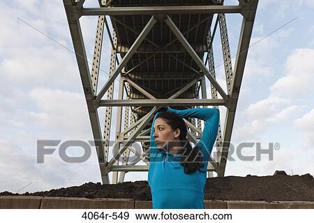 Female urban athlete stretching View Large Photo Image Stock Photo - Female urban athlete stretching. Fotosearch