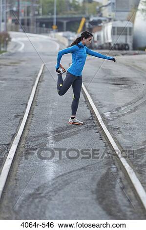 Female urban athlete stretching View Large Photo Image Stock Photograph - Female urban athlete stretching. Fotosearch