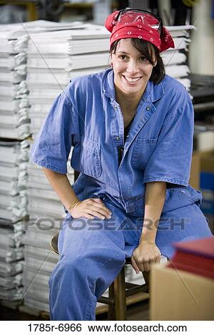 Stock Photograph - Female worker in a storage warehouse. Fotosearch