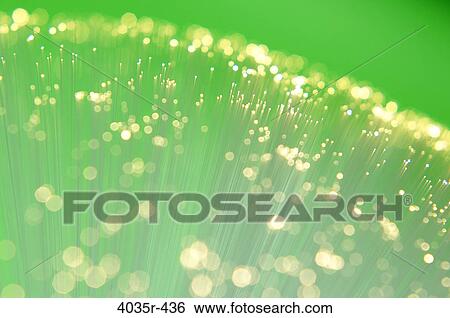 Stock Photograph - Fiber optic cables against green background. Fotosearch