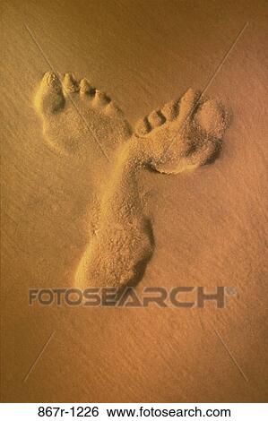 Stock Photograph - Footprints in the sand. Fotosearch